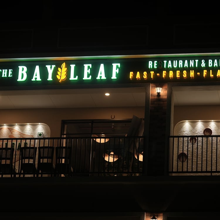 Bayleaf Restaurant & Banquet signboard at night, Anand